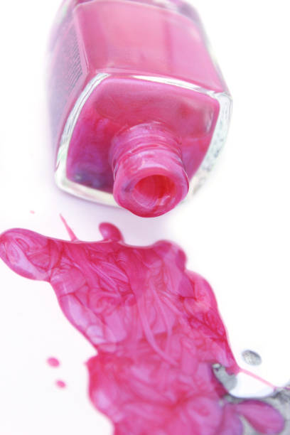 istock Pink and Silver Nail polish Spilled on White 1261049652
