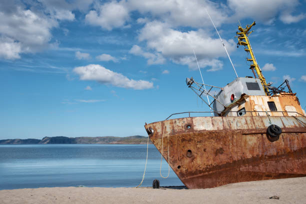 istock Bright rusty old abandoned fishing boat on the coast 1261089103