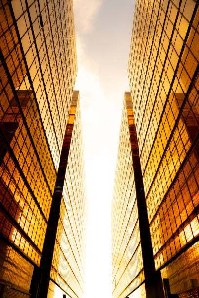 istock Looking up at golden skyscrapers 1261094301