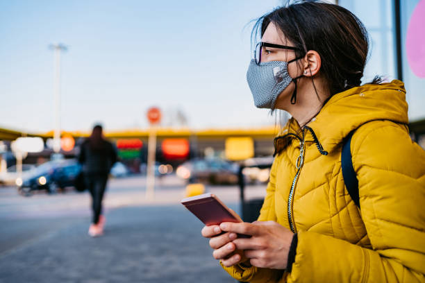 istock Woman in shopping mall with face mask using phone 1261098040