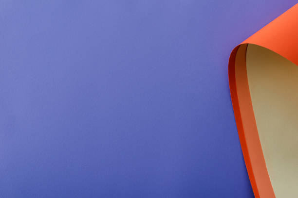 istock colorful paper swirl on violet background 1261100224