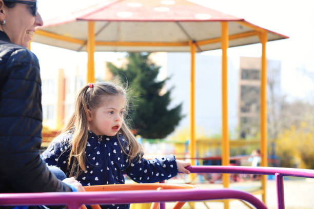 istock Mother and her daughter having fun in a playground 1261109847