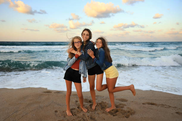 istock Three girls having fun on the beach 1261111655