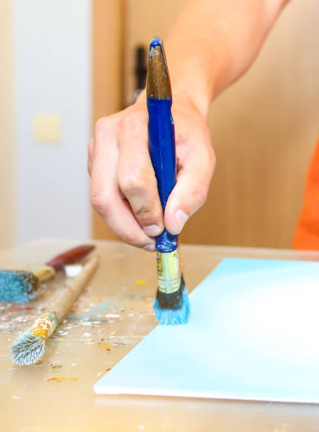 istock Paint palette. Real work studio of the painter. Man is creating picture. Artist concept. Creative atmosphere. 1261119201