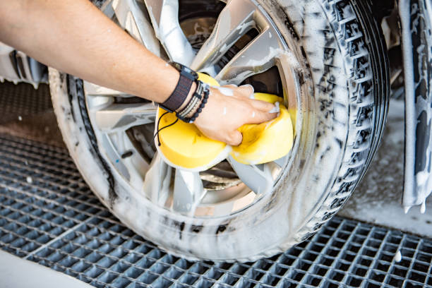 istock man hand holding yellow sponge cleaning car 1261130883