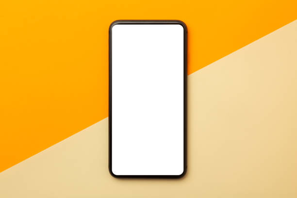 istock Flat lay, top view of orange office table desk with smartphone blank screen mockup with clipping path. Modern working space 1261131171