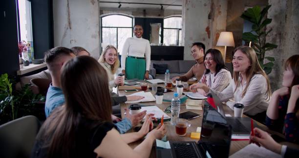 istock Teamwork at office meeting table, multiethnic colleagues brainstorm with confident young African female boss slow motion 1261133342