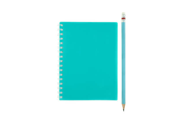 istock Pencil on top of book on the white background 1261134417