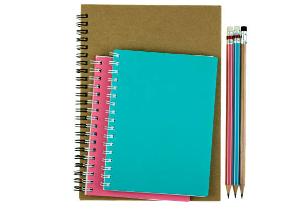 istock Pencil on top of book on the white background 1261134431