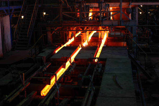 istock Red hot steel metal billets after molten steel casting.  Continuous casting machine. Background of the blacksmith and metallurgical industry. 1261135986