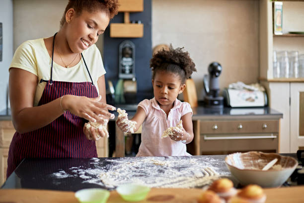 istock Mother Teaching 3 Year Old Daughter How to Work with Dough 1261143304