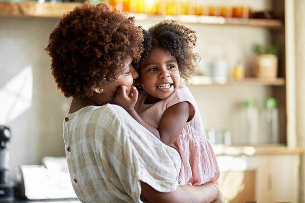 istock Afro-Caribbean Mother and Young Daughter Showing Affection 1261144893