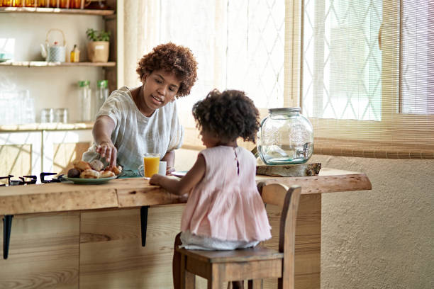 istock Young Mother and Daughter Enjoying Breakfast Together 1261144896