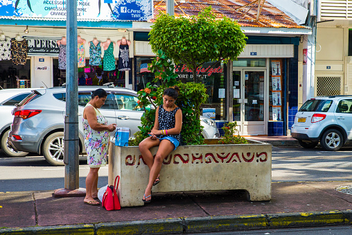 view on the City center in Papeete, French Polynesia. Daily life in one of the most beautiful tropical islands in the world. People walking and sitting around in the city center.