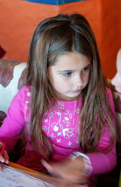 istock small girl with a coloring book 1261155538