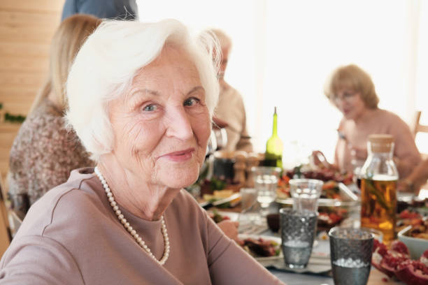 Grandmother having dinner while talking in the dining room on christmas at home