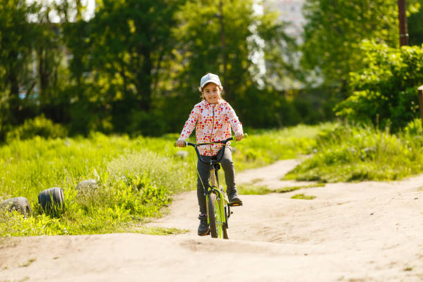 istock Happy little girl with her bicycle 1261157221