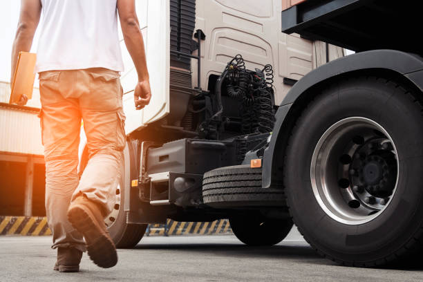 A truck driver walking around semi truck his inspecting and safety check to before driving semi truck. truck transportation,  A truck driver walking around semi truck his inspecting and safety check to before driving semi truck. semi truck stock pictures, royalty-free photos & images