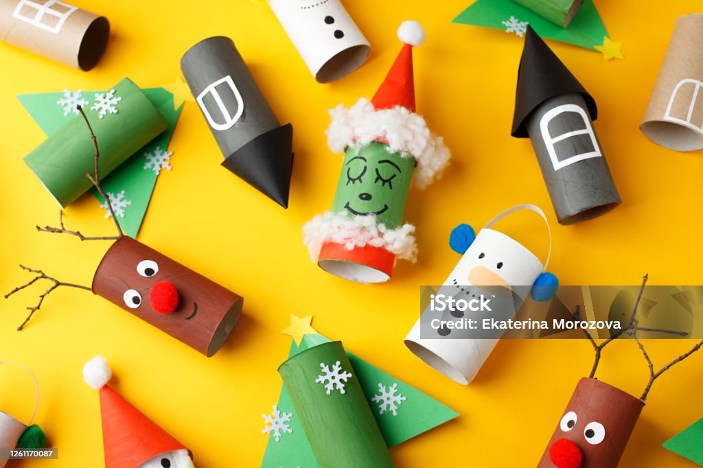 Christmas new year crafts, paper santa, snowman, grinch on yellow paper background with copy space for text. Winter holiday concept handcraft, diy, idea toilet roll, recycle Christmas Stock Photo