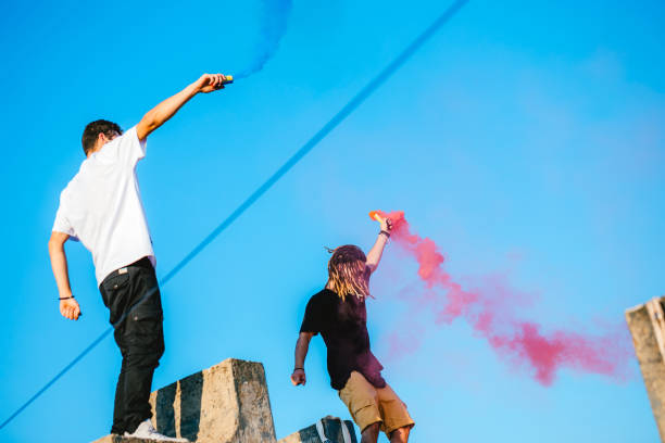 istock Releasing a colored smoke bomb on rooftop 1261174360