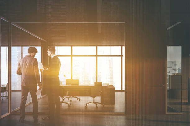 istock Businessmen in dark grey CEO office 1261220995