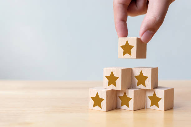 istock Hand arranging wood block stacking as step stair with five star shape. The best excellent business services rating customer experience concept 1261225461