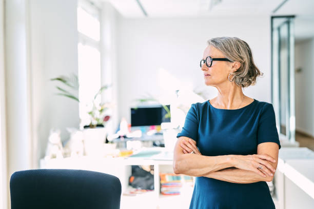 istock Thoughtful businesswoman standing in office 1261229876