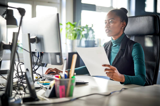 istock Businesswoman working at computer desk in office 1261232548