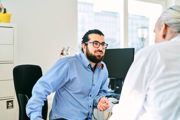 istock Businessmen discussing in creative office 1261239472
