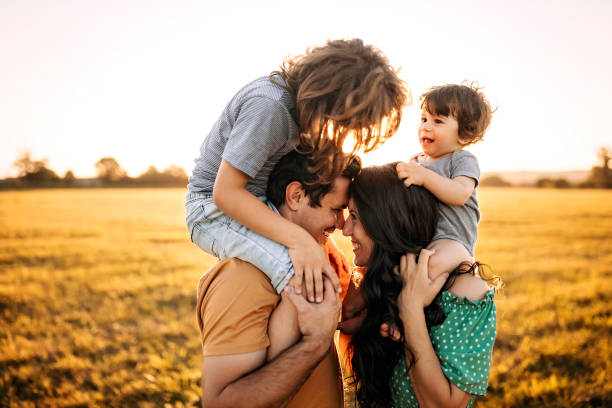 istock Parents with kids playing in sunset 1261262322