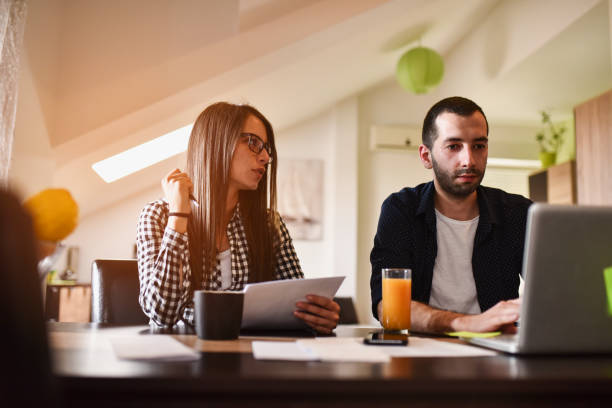 istock Couple working laptop office home business 1261263406
