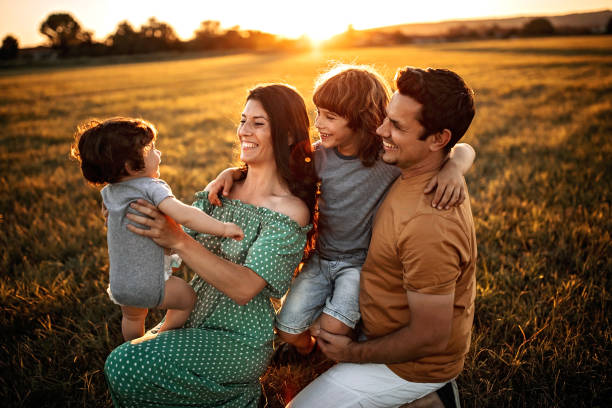 istock Young family walking in sunset 1261269528