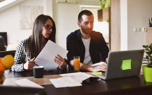 istock Couple working laptop office home business 1261274456