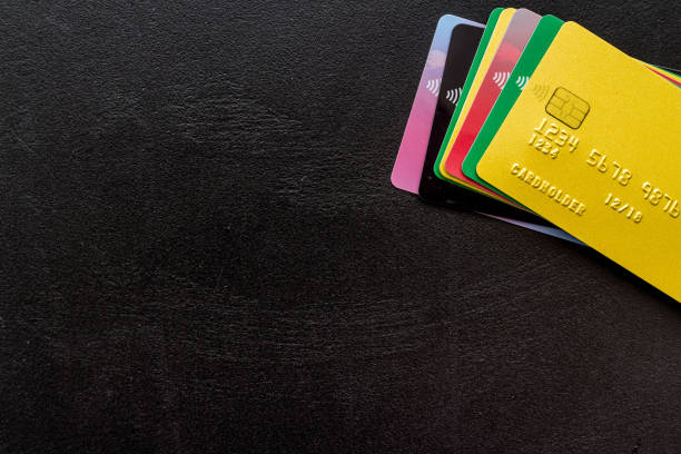 istock security concept. stack of credit card on black desk top-down copy space 1261286052