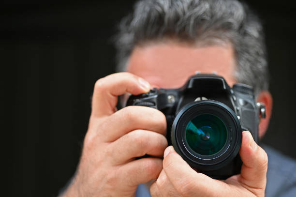 istock Man photographer photographing with a camera 1261291063