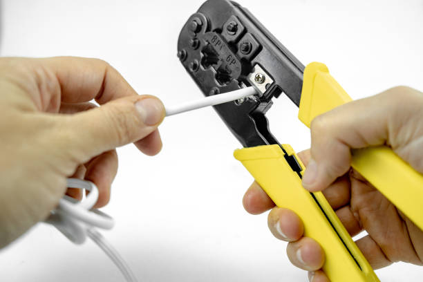 istock internet or telephone line cables and crimper, Twisting Cable Tool Twisted Pair Ethernet UTP Cat 5, Crimping RJ45 LAN cable, Stepping to crimping RJ45 connector 1261293779