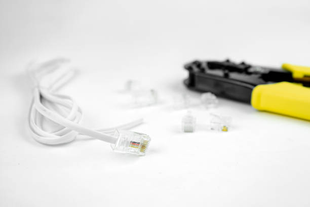 istock internet or telephone line cables and crimper, Twisting Cable Tool Twisted Pair Ethernet UTP Cat 5, Crimping RJ45 LAN cable, Stepping to crimping RJ45 connector 1261293801