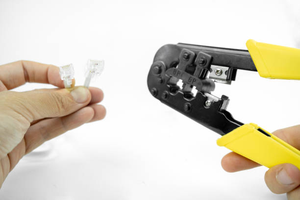 istock internet or telephone line cables and crimper, Twisting Cable Tool Twisted Pair Ethernet UTP Cat 5, Crimping RJ45 LAN cable, Stepping to crimping RJ45 connector 1261293805
