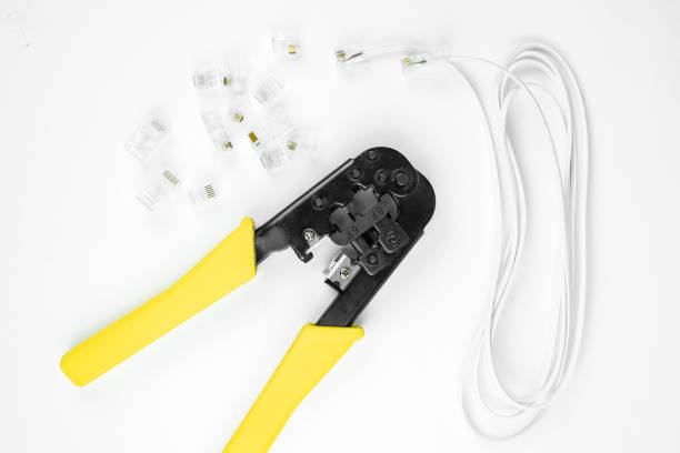 istock internet or telephone line cables and crimper, Twisting Cable Tool Twisted Pair Ethernet UTP Cat 5, Crimping RJ45 LAN cable, Stepping to crimping RJ45 connector 1261293814