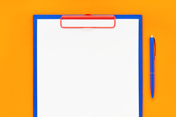 Blank clipboard mockup and blue pen on orange color background. Top view, copy space for text. Back to school, deadline, morning concept.