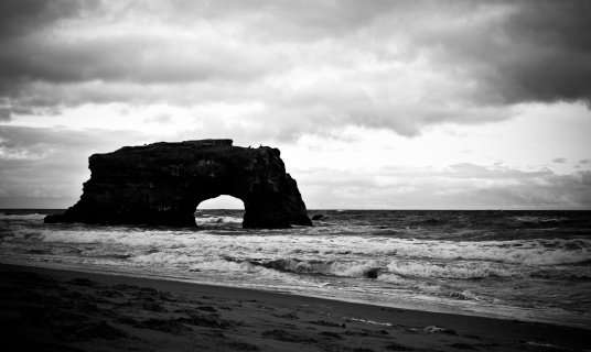 Natural Bridge in Santa Cruz in black and white during a stormy day.