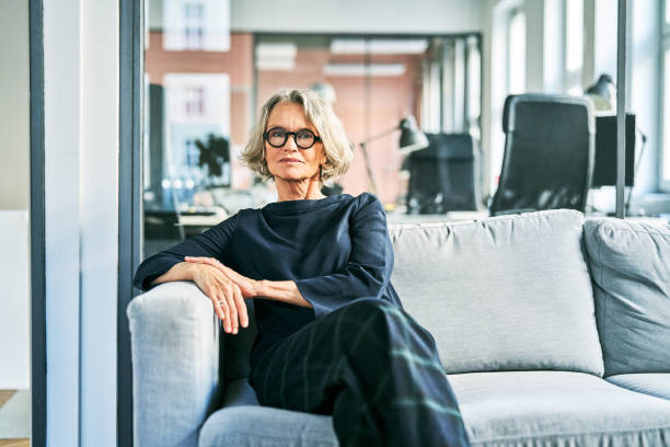 istock Businesswoman sitting on sofa in creative office 1261314067