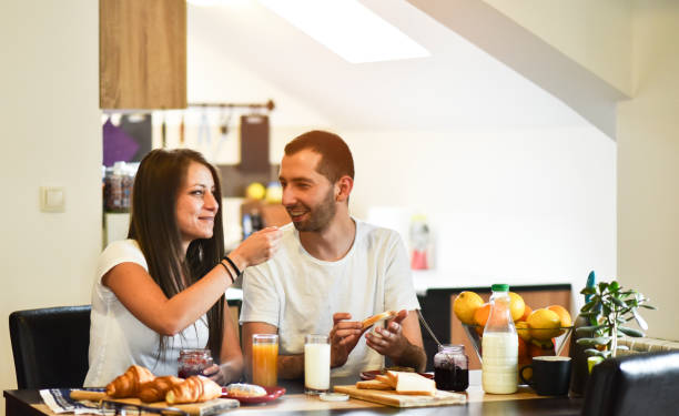 istock Cute young couple enjoying their breakfast together 1261331479
