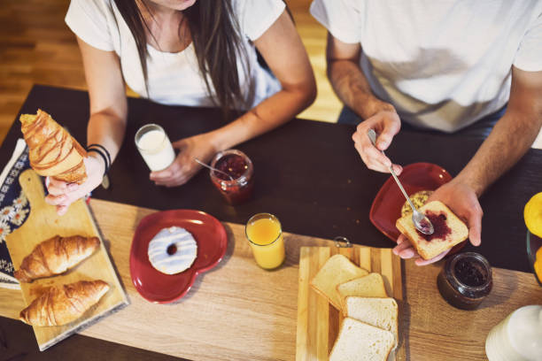 istock Cute young couple enjoying their breakfast together 1261332031
