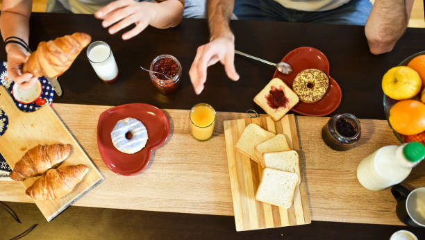 istock Cute young couple enjoying their breakfast together 1261333071