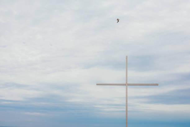 big cross with sea on the background. religion concept and selective focus .