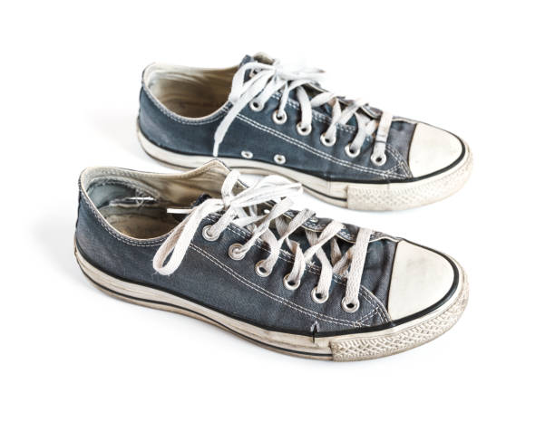 istock Old blue sneakers isolated on white background 1261362300