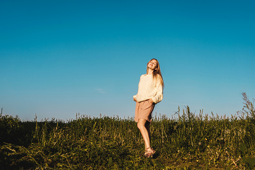 Enjoyment. Free happy woman enjoying nature. Beauty Girl Outdoor. Freedom concept, blue sky background.
