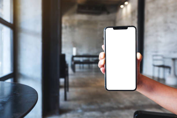 istock a woman holding and showing mobile phone with blank white desktop screen 1261374637