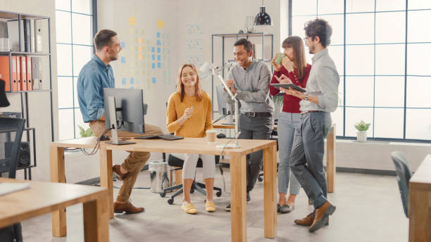 istock In the Modern Office: Diverse Group of Colleagues Have Meeting, Develop Strategy, Discuss Project Progress, Customer Experience Management also Have a bit Of Fun and Jokes. Smiling Businesspeople Chat 1261396400